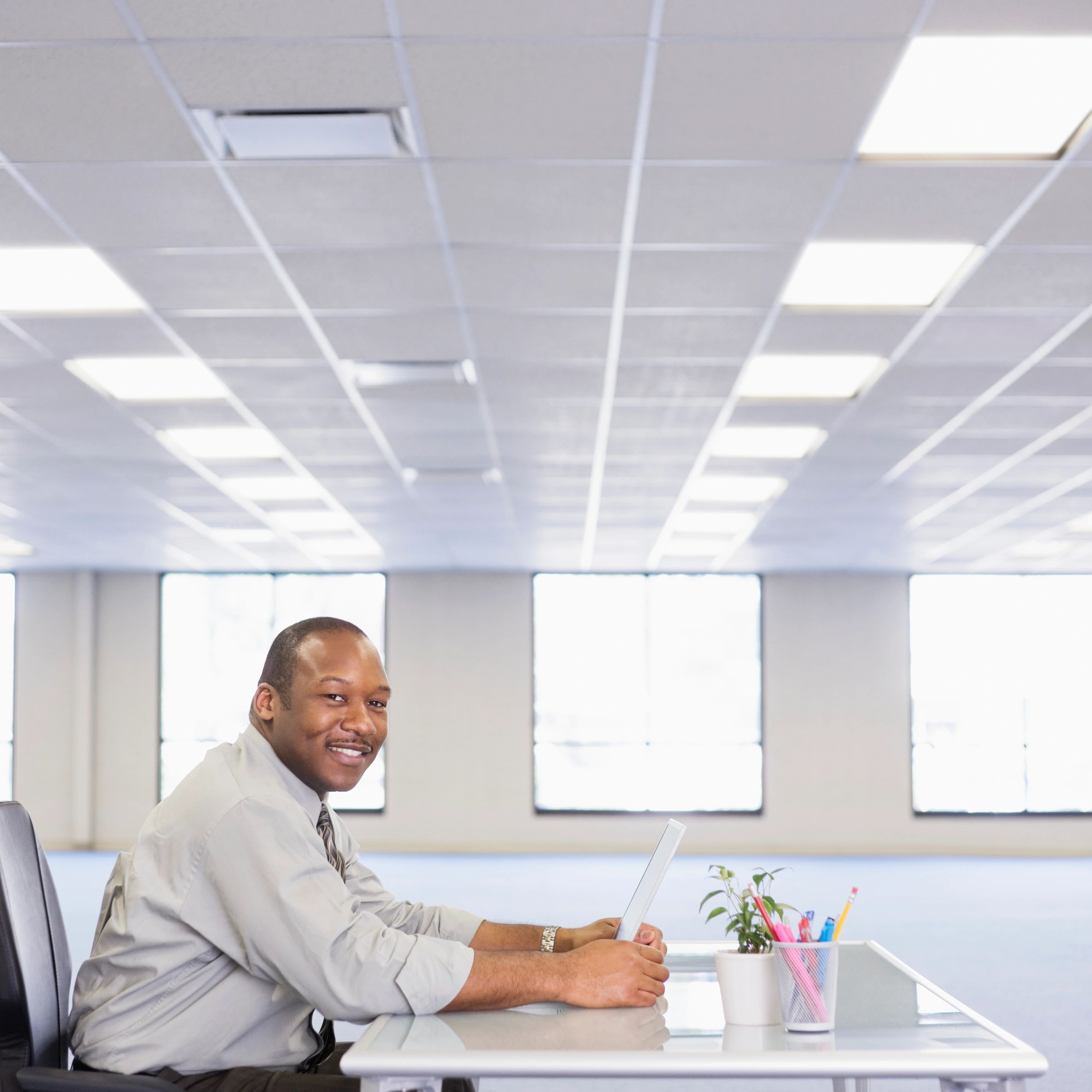 Black African student smiling with a laptop